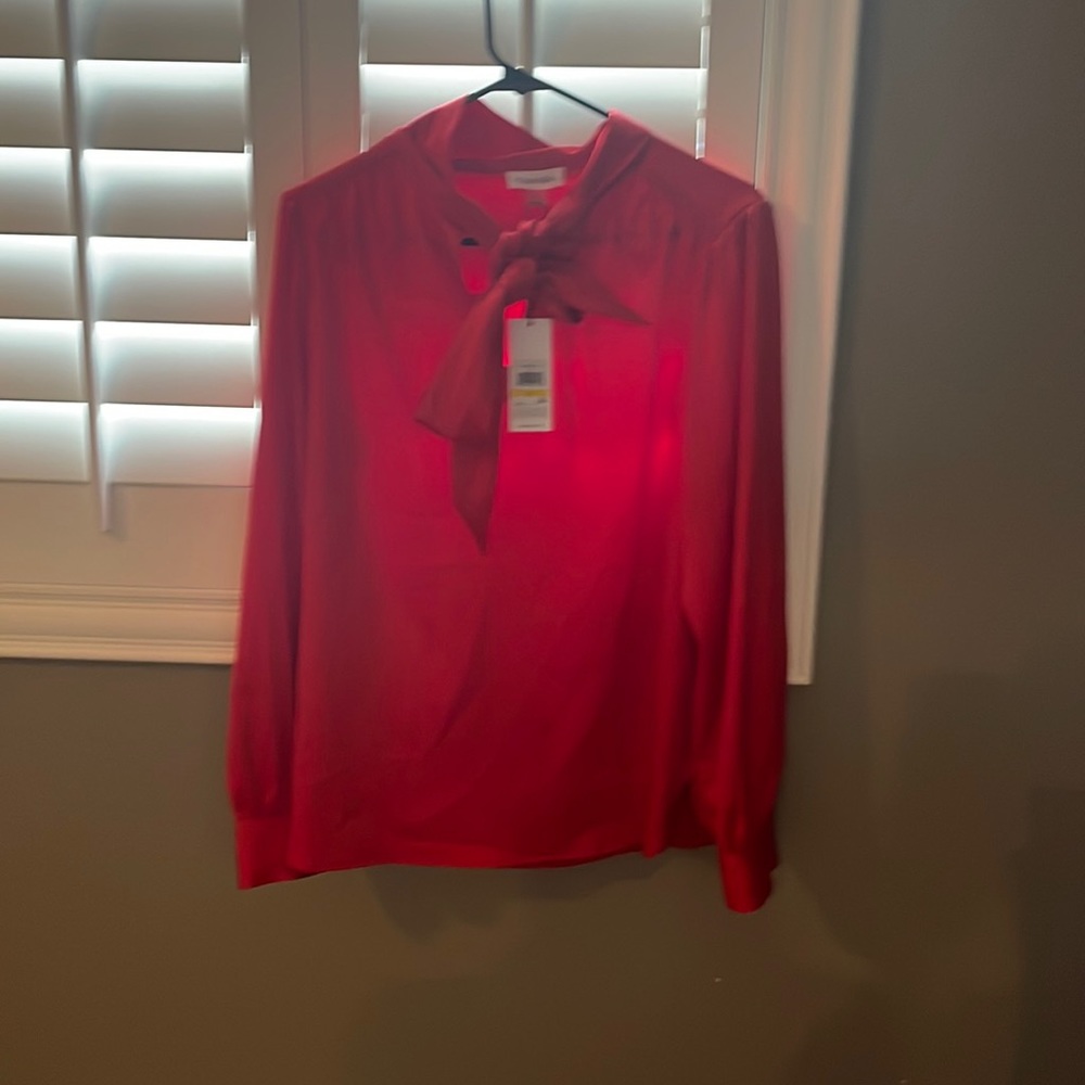 Tags on red work suit blouse